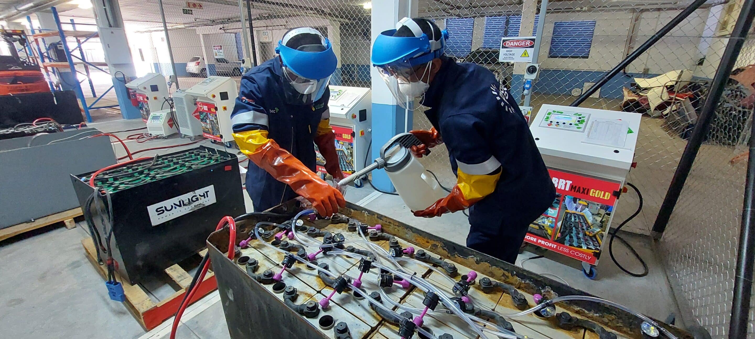 Two technicians in protective gear regenerating a traction battery at Be Energy’s Johannesburg center